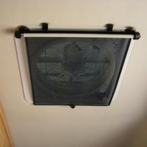 Retractable window shade over Maxx air vent to help block light for sleeping while still allowing ventilation.