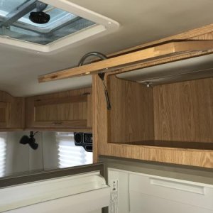 Storage above refrigerator.  Microwave would go here and has a 120 volt outlet in the back.