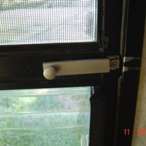 Screen Door Safety Latch, accessible thru sliding panel from outside.