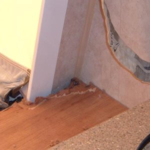 Front Shelf 3: road side.  This is view after removing moulding.  It shows water damaged to the mdf board.