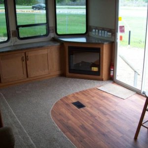 Front bay windows, fireplace, entertainment area, patio doors, and the stools for the breakfast area.