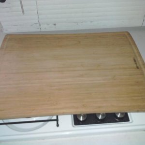 Cutting board. Shelf mat material holds it on during travel.