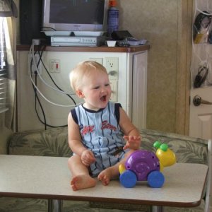 Grandbaby sitting on table "just for picture :>) " inside our Antiqua