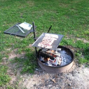 Bacon for breakfast on the open campfire.