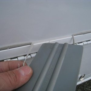 Once you trace around the edge with the plastic squeegee, the butyl tape just peels off and away from the wall.