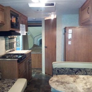 Looking aft from front queen bed.
From left to right:
Fold down couch, 3 burner stove (microwave overhead), rear queen bed, bathroom, Fridge w/ freeze