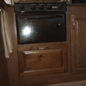 cabinet door to access space under stove