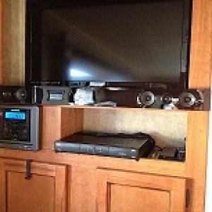 A/V center after moving radio/DVD player to left.  Removed the blanking plates, added a cherry filler to the right of the radio and fill plate to clos