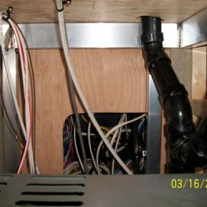 View of the Power Panel rear, as viewed from the pass through storage area.  Looking over top the Furnace.