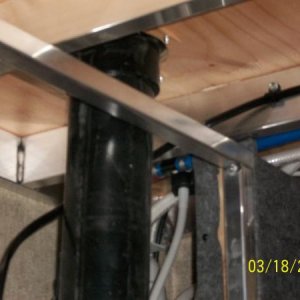 The wire is routed along the floor joist, and passes above the storage compartment wall, behind the toilet pipe, and over to the Power Distribution Pa