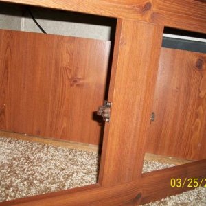 A panel in the TV Cabinet lower storage area is there to prevent items from going back where the wires and BBQ LP hose is located.