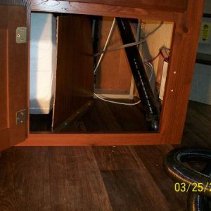 The piece of divider paneling removed from in the Lower TV Cabinet Mod fits perfectly in front of the Water Heater plumbing as protection from items s