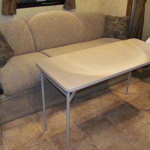 Our much lighter and narrower table by Cosco. 20"X48"

http://www.coscoproducts.com/eng/Products/Indoor-Furniture/Folding-Tables/