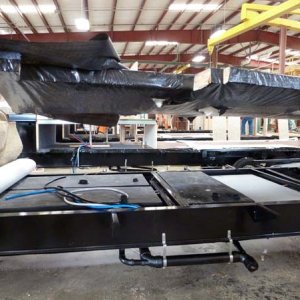 In the Forest River factory. The frame for the floor is about to be lowered onto the chassis.