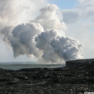 Steam from lava flowing into the ocean.