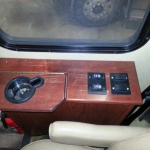 Back row of light switches on passenger arm rest.  1 operates passenger map light, other operates outside LED light strip.