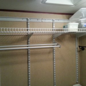 Towel drying rack and storage in bathroom.