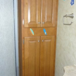 Bathroom sink on the right, cabinet straight ahead, and shower on the left.