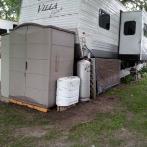 This shows the propane tanks relocated to the right of the sheds.