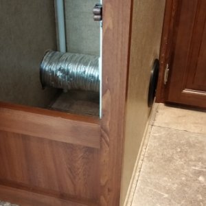 Moved the vent from under the shower and put it through the wardrobe out the side by the back bed.