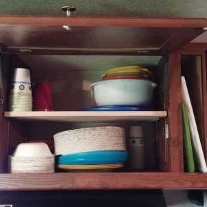 Put in adjustable shelf in cabinet above stove. Also removed panel between cabinet and microwave and fits my cutting boards perfectly.