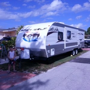 My son standing in front of our trailer as we finished up cleaning it before storing it away from our summer trip to Sebastian Inlet Florida