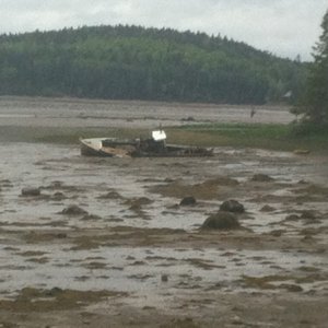 Old boat stuck in the mud, low tide