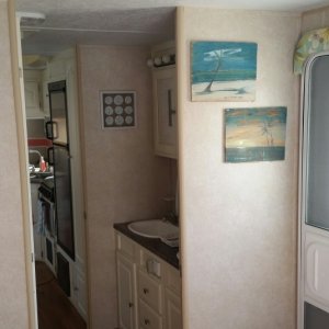 Looking from bedroom to vanity and into kitchen