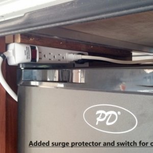 Added surge protector with on/off switch for outside fridge