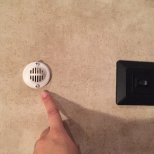 Small round vent above light switch.