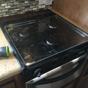 We rarely cook on the stove, so I made a plexiglass cover for the stove.  This cover sits flat (about 1.5" lower than the metal grate) so we can more 