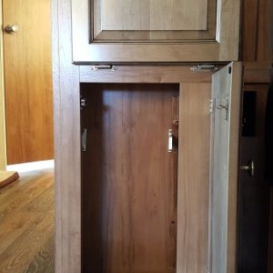 We decided on the lower cabinet space in our entertainment center is a good space for garbage. Installed brackets that plastic grocery bags hang from.