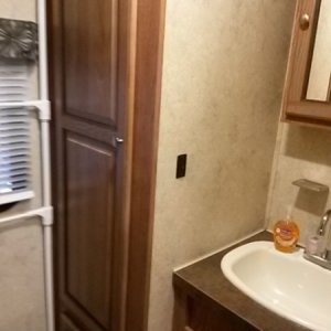 bath wardrobe cabinet and sink (water heater located in cabinet below wardrobe cabinet)