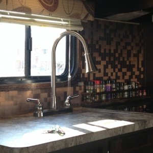 Backsplash, spice rack and trim around window.