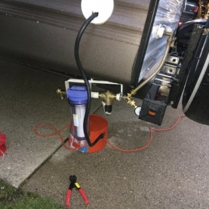 Water filter "installed".  The bracket attaches to a cable under the camper so I can hook it on when I arrive at the campsite.