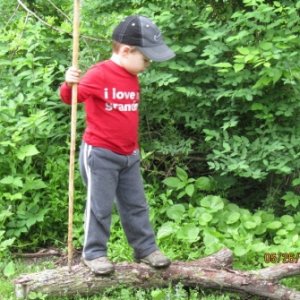 Learning with his own walking stick. Kids need to be out more often in the woods.