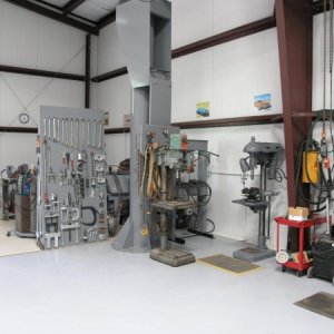 In this picture, the drill press in the middle is a variable speed Powermatic 20" awaiting restoration, slightly to the right is a 50 hydraulic press,