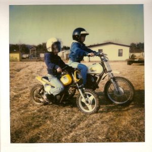 My sons on a white Yamaha MX80 & a yellow PW50. Mid 1980's.