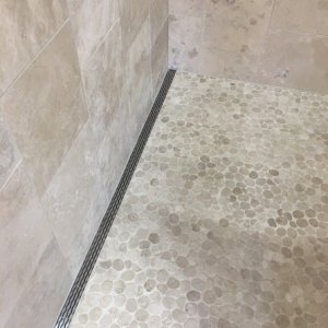 Shower floor with side drain