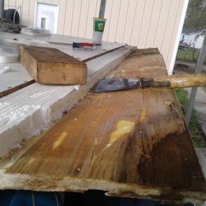 peeling each layer of bad wood off layer at a time...so i could save the underlying roof membrane