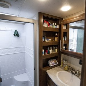 The bathroom with full size shower and plenty of storage.