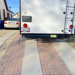 I got tired of crawling under the trailer to get the sewer hose out. So, I added a hose carrier on the back. It is much easier to access. So now I car