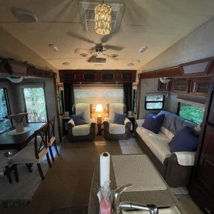 Living Area:
We removed all stock window valances and wallpaper border, updated the pendant light shades, unbolted the table from the floor and turned