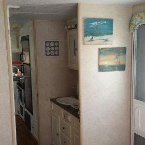 A look from bedroom to vanity and into kitchen