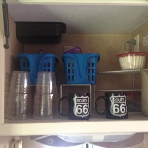 Above sink storage- before adding items for trip!  Notice the coffee cups?