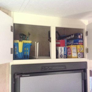 Storage above fridge.  Paper products stay in cabinet year round