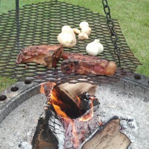 Self raised pork chops over an open fire