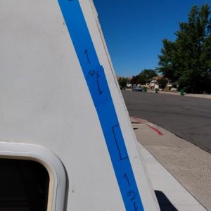 Masking tape showing where framing is for attaching exterior underlayment/luan