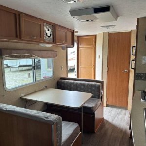 Large closet just inside door. Bathroom in rear corner. Dinette converts to extra bed and has storage under both seats. Cabinet over dinette — the end