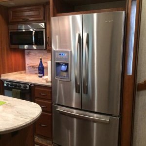 New fridge with new door keeper to keep the doors closed.